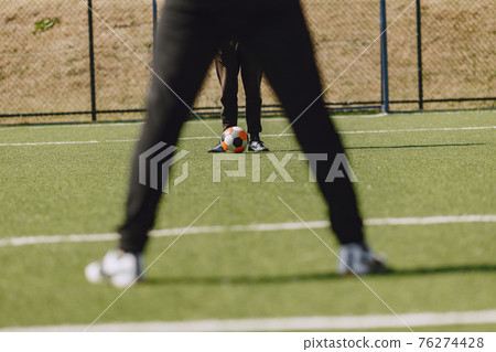 Spormen is playing football and practising with the ball 76274428
