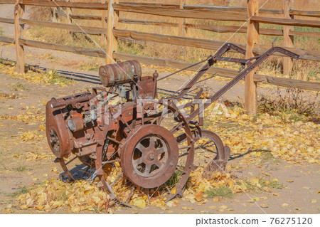 Antique walk behind gas powered tilling equipment used in the 1800's in Utah 76275120