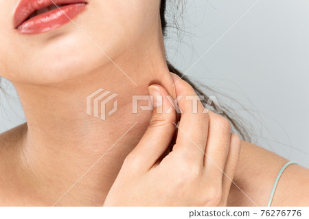 A woman who massages her neck 76276776