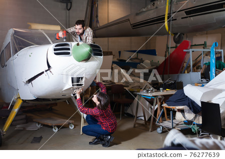 Adult male with female working in workshop Adult male with female working in workshop 76277639