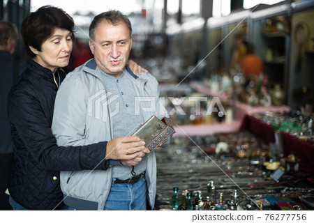 Couple is looking jewelry box at the retro market Couple is looking jewelry box at the retro market 76277756
