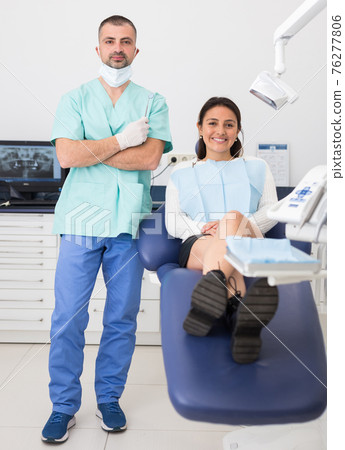 Portrait of positive dentist and happy cute woman Portrait of positive dentist and happy cute woman 76277806
