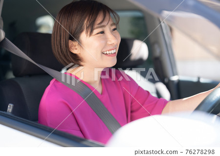 A young woman driving a car A young woman driving a car 76278298