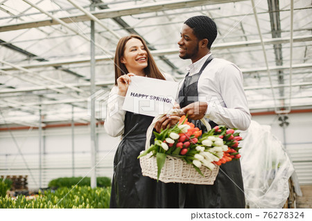 Flower sellers with a sign and with tulips 76278324