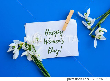 Happy Womens Day lettering greeting card. Spring flowers snowdrop. Beautiful tender bouquet of flowers. Holiday concept 76279253
