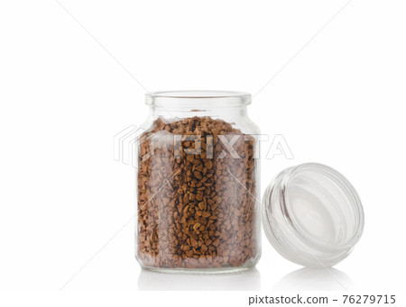 The aromatic granules of instant coffee are in a glass jar. The aromatic granules of instant coffee are in a glass jar. 76279715