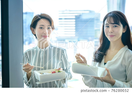 Business woman eating takeaway lunch at the office Business woman eating takeaway lunch at the office 76280032