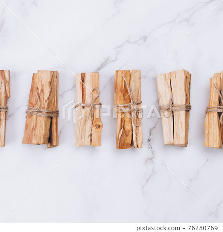 Square composition with Palo Santo tree sticks on marble background - holy incense tree from Latin America. Meditation, mental health and personal fulfilment concept. Selective focus 76280769