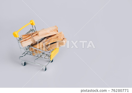 Palo Santo tree sticks inside shopping cart on light gray background - holy incense tree from Latin America. Meditation, mental health and personal fulfilment concept. Selective focus 76280771