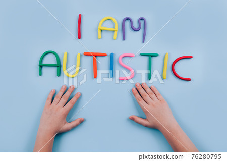 World Autism Awareness Day concept - multicolored letters, Am I Autistic - child hands playing against blue background. Autism spectrum disorder and child mental health concept. Selective focus World Autism Awareness Day concept - multicolored letters, Am I Autistic - child hands playing against blue background. Autism spectrum disorder and child mental health concept. Selective focus 76280795