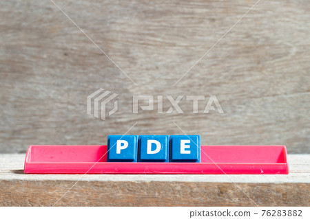 Tile letter on red rack in word PDE (abbreviation of permitted daily exposure, partial differential equation or personal development education) on wood background Tile letter on red rack in word PDE (abbreviation of permitted daily exposure, partial differential equation or personal development education) on wood background 76283882