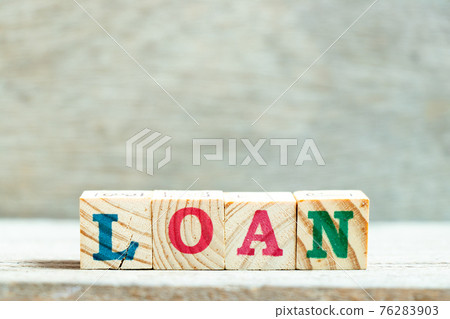 Alphabet letter block in word loan on wood background 76283903