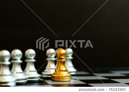 Gold pawn piece stand in fron of silver pawn team on black background (Concept for leader, unique or outstanding) Gold pawn piece stand in fron of silver pawn team on black background (Concept for leader, unique or outstanding) 76283905