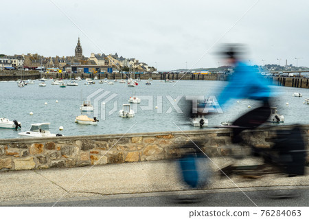 A heavily packed cyclist arriving in Roscoff, France, after a long journey A heavily packed cyclist arriving in Roscoff, France, after a long journey 76284063