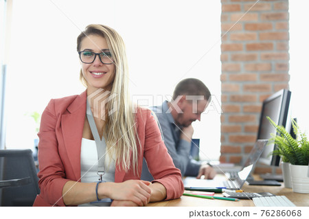 Portrait of smiling businesswoman with glasses in office Portrait of smiling businesswoman with glasses in office 76286068