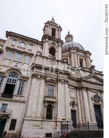 Sant'Agnese in Agone baroque church facade view at martyrdom site with frescoes. 17th-century Roman architecture sight. Travel Rome, Italy. Sant'Agnese in Agone baroque church facade view at martyrdom site with frescoes. 17th-century Roman architecture sight. Travel Rome, Italy. 76286349