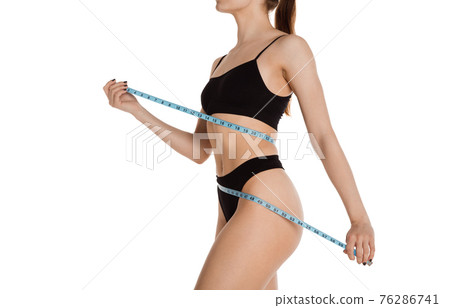 Cropped slim tanned beautiful woman in underwear isolated over white background. 76286741