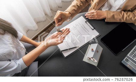 Real estate agent holding a key and asking costumer for contract to buy, get insurance or loan real estate or property. Real estate agent holding a key and asking costumer for contract to buy, get insurance or loan real estate or property. 76287026