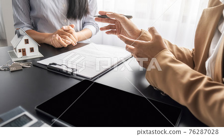Real estate agent and customer discussing for contract to buy, get insurance or loan real estate or property. Real estate agent and customer discussing for contract to buy, get insurance or loan real estate or property. 76287028