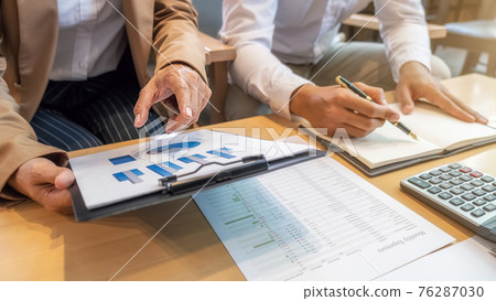 Business team brainstorming and discussing with financial data and report graph. Teamwork meeting working concept. Business team brainstorming and discussing with financial data and report graph. Teamwork meeting working concept. 76287030