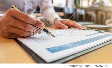 Businessman discussing the charts and graphs showing the results of their successful teamwork. Business concept. Businessman discussing the charts and graphs showing the results of their successful teamwork. Business concept. 76287032
