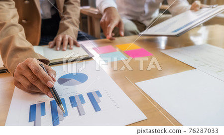 Business team brainstorming and discussing with financial data and report graph. Teamwork meeting working concept. Business team brainstorming and discussing with financial data and report graph. Teamwork meeting working concept. 76287033