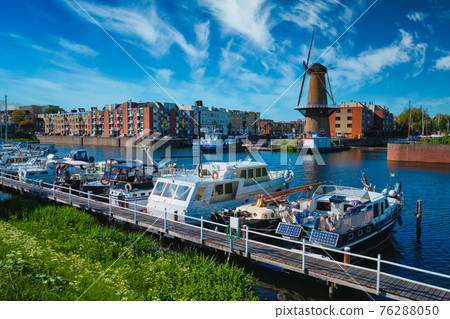 View of the harbour of Delfshaven and the old grain mill De Destilleerketel. Rotterdam, Netherlands View of the harbour of Delfshaven and the old grain mill De Destilleerketel. Rotterdam, Netherlands 76288050