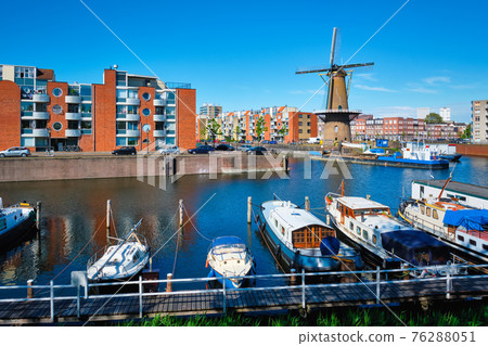 View of the harbour of Delfshaven and the old grain mill De Destilleerketel. Rotterdam, Netherlands View of the harbour of Delfshaven and the old grain mill De Destilleerketel. Rotterdam, Netherlands 76288051