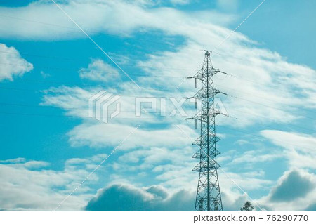 High-voltage tower that shines in the blue sky 76290770