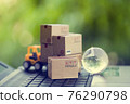Logistic and cargo freight concept: Fork-lift a truck moves a paper box on notebook keyboard. depicts International freight or shipping service for online shopping. 76290798