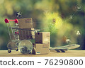 Shopping Online and e-commerce concept: Paper boxes in a shopping cart and crystal globe, plane. Online stores are considered as another medium of trading goods between entrepreneurs and customers. 76290800