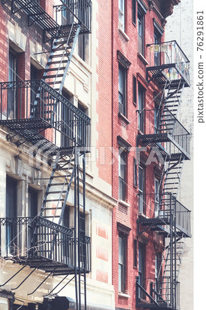 Picture of old buildings with fire escapes, color toning applied, New York City, USA. 76291861