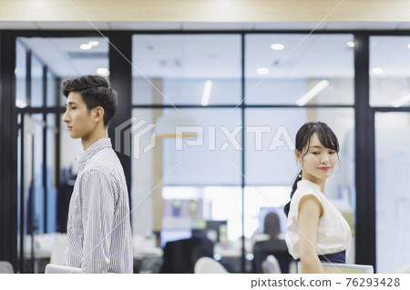Men and women standing back to back in the office business scene Men and women standing back to back in the office business scene 76293428