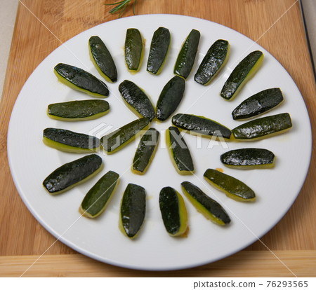 Preparing fresh cooked courgette, zucchini on wood table Preparing fresh cooked courgette, zucchini on wood table 76293565