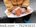 1 year old hand and fallen leaves 76293815