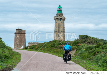 Cycling towards the lighthouse of Cap Frehel on Eurovelo 4, Bretagne, France. Cycling towards the lighthouse of Cap Frehel on Eurovelo 4, Bretagne, France. 76296115