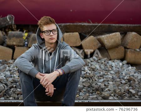 Young handsome teenage boy at the railway train station 76296736