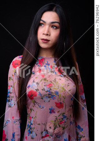 Young beautiful Asian transgender woman against black background Young beautiful Asian transgender woman against black background 76296942