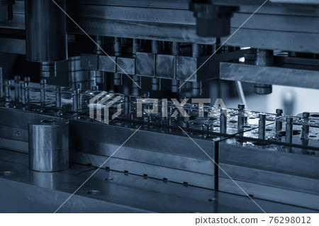Close-up scene of progressive die operation. Close-up scene of progressive die operation. 76298012