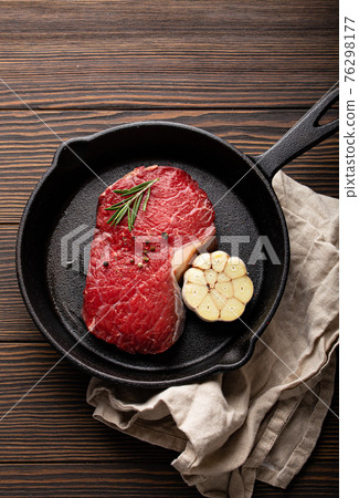 Raw beef steak on frying pan from above Raw beef steak on frying pan from above 76298177
