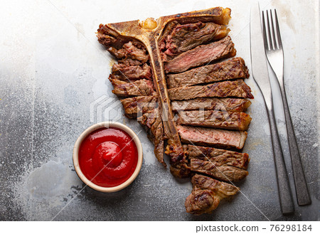Sliced grilled T-bone beef steak from above 76298184