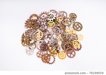 Pile of gear wheels and cogs in different colors Pile of gear wheels and cogs in different colors 76299059
