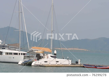 yacht or fishing boats near the sea at the port in Phuket 76299278