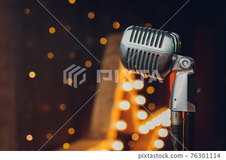 Retro microphone on bright curtain background close-up. 76301114