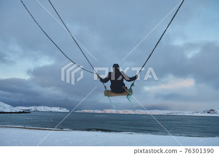 Beautiful woman with cup of tea on Swing. River on background, nature and calm. Self isolation. Beautiful woman with cup of tea on Swing. River on background, nature and calm. Self isolation. 76301390