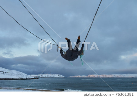 Beautiful woman with cup of tea on Swing. River on background, nature and calm. Self isolation. Beautiful woman with cup of tea on Swing. River on background, nature and calm. Self isolation. 76301391