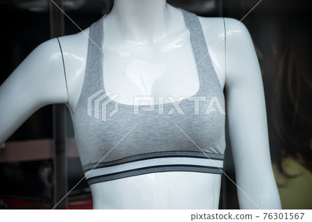 Closeup of grey fitness bra on mannequin in a fashion store showroom 76301567