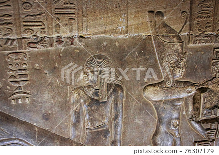 Mysterious murals on the walls of the Temple of Dendera Hathor , near the city of Ken. Electric lamps in the image 76302179