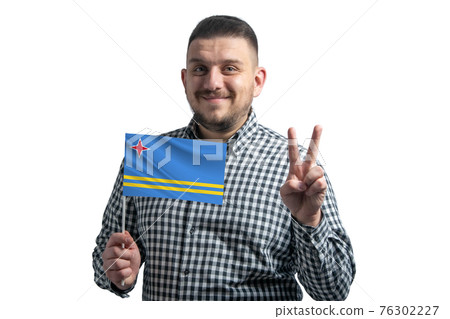 White guy holding a flag of Aruba and shows two fingers isolated on a white background White guy holding a flag of Aruba and shows two fingers isolated on a white background 76302227