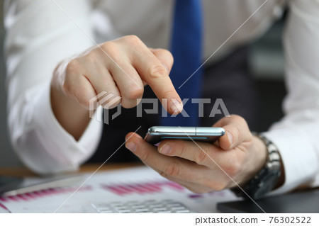 Close-up of businessman using modern smartphone closeup 76302522